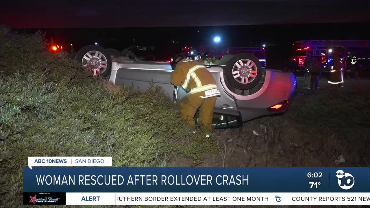 Crews rescue woman trapped in car after rollover crash