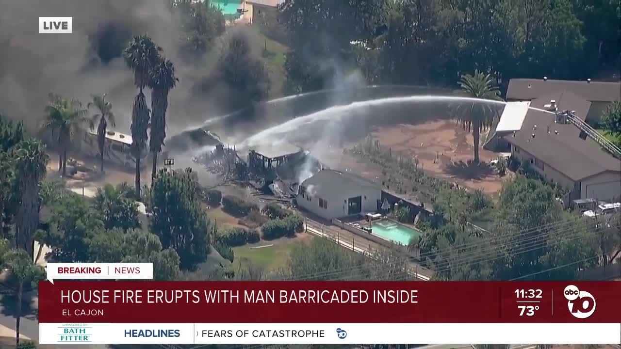 Fire burns El Cajon home with man barricaded inside